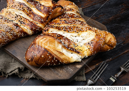 Baked Pastry triangle With Savory Filling Of Cheese, on old dark  wooden table background 103253519