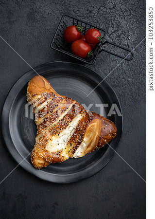 Burekas filled with cheese painir , on black dark stone table background, top view flat lay Burekas filled with cheese painir , on black dark stone table background, top view flat lay 103253850