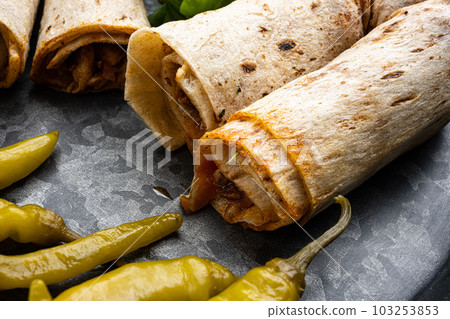 Street food chicken tantuni Turkish doner, close up macro Street food chicken tantuni Turkish doner, close up macro 103253853