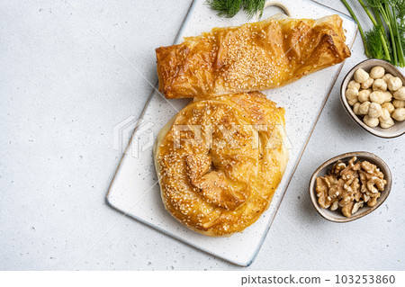 Turkish pastry filled with cheese, on gray concrete table background, top view flat lay, with copy space for text 103253860