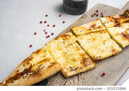 Traditional Turkish baked pide dish, on gray concrete table background, with copy space for text Traditional Turkish baked pide dish, on gray concrete table background, with copy space for text 103253866