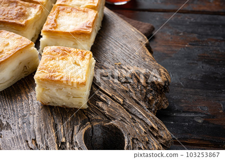 Turkish Pastry for Breakfast Su Boregi, on old dark wooden table background, with copy space for text Turkish Pastry for Breakfast Su Boregi, on old dark wooden table background, with copy space for text 103253867