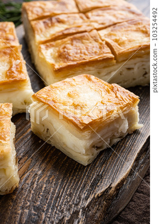 Pastries Kol Boregi, Sigara Boregi, on old dark wooden table background Pastries Kol Boregi, Sigara Boregi, on old dark wooden table background 103254492