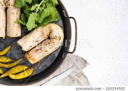 Turkish Style chicken roll Tavuk Durum tantuni, on gray concrete table background, top view flat lay, with copy space for text 103254502