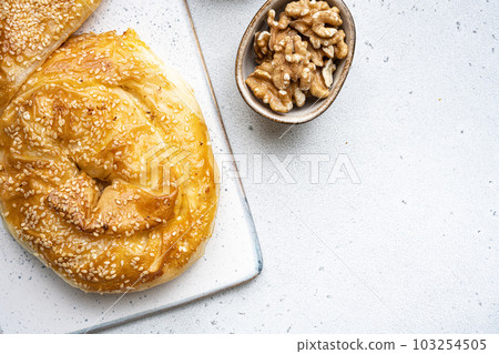 Burekas filled with cheese painir , on gray concrete table background, top view flat lay, with copy space for text Burekas filled with cheese painir , on gray concrete table background, top view flat lay, with copy space for text 103254505