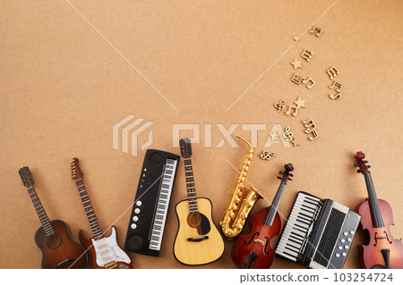 Happy world music day. Musical instruments on brown background. 103254724