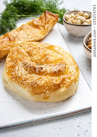 Turkish pastry filled with cheese, on gray concrete table background Turkish pastry filled with cheese, on gray concrete table background 103254761