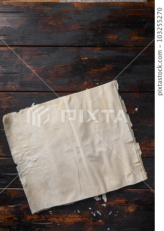 Filo dough over old dark wooden table top view. 103255270