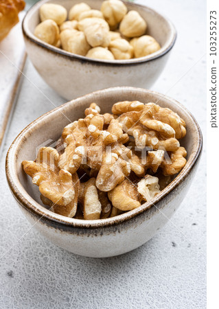 Nuts in bowl, on white stone table background 103255273