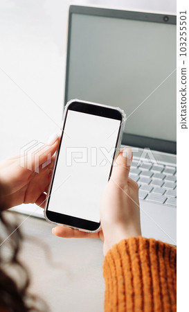 Modern Woman Using Smartphone with Blank Screen for Apps or E-Learning in Over Shoulder View 103255501