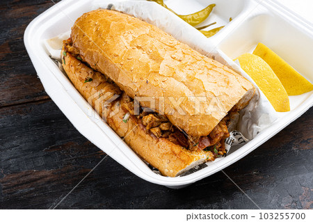 Tantuni, Traditional Turkish Kebap with Chicken, in plastic pack container delivery lunch box, on old dark wooden table background Tantuni, Traditional Turkish Kebap with Chicken, in plastic pack container delivery lunch box, on old dark wooden table background 103255700