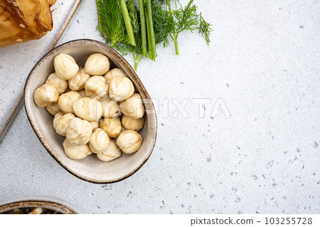Nuts in bowl, on white stone table background, top view flat lay, with copy space for text 103255728