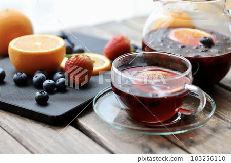 Warm herbal tea with plenty of fresh fruit Warm herbal tea with plenty of fresh fruit 103256110