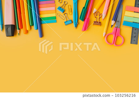 School supplies from above yellow background 103256216