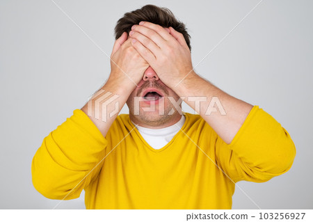 Anonymous caucasian man hiding his identity . Studio shot Anonymous caucasian man hiding his identity . Studio shot 103256927