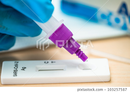Asian doctor holding Saliva Antigen Test Kit for check Covid19 coronavirus in hospital. Asian doctor holding Saliva Antigen Test Kit for check Covid19 coronavirus in hospital. 103257587