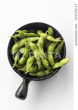 japanese edamame beans snack in black ceramic bowl on white background japanese edamame beans snack in black ceramic bowl on white background 103258117