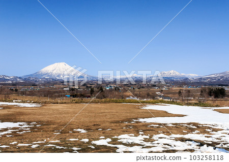 Mt. Yotei and Mt. Shiribetsu seen from the top of a hill in Toyako, Hokkaido [April] 103258118