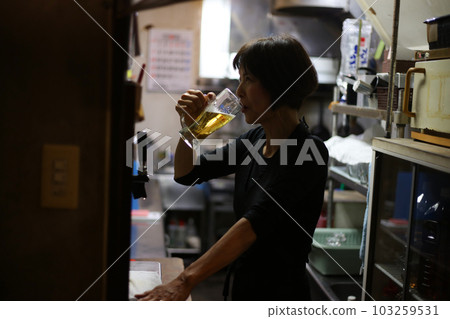 woman drinking beer after work woman drinking beer after work 103259531