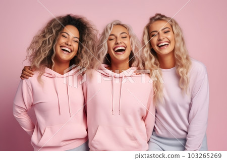 Three female friends in wearing sport clothes, laughing happily on pink background. Generative Ai 103265269