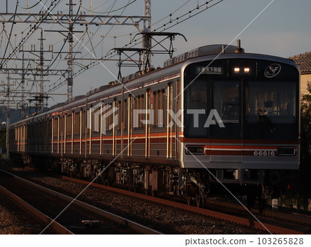 Series 66 running on the Hankyu Kyoto Line at dusk Series 66 running on the Hankyu Kyoto Line at dusk 103265828
