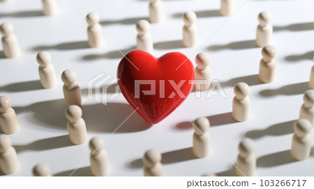 Red toy heart among crowd of people closeup Red toy heart among crowd of people closeup 103266717