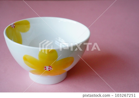 A teacup with a yellow flower pattern. A teacup with a yellow flower pattern. 103267251
