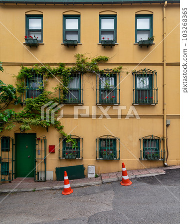 House with walls painted in orange and green, and wrought iron window, at a narrow street, Uskudar, Istanbul, Turkey House with walls painted in orange and green, and wrought iron window, at a narrow street, Uskudar, Istanbul, Turkey 103268365