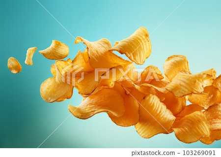 Flying and falling crispy wavy potato chips. Generative AI Flying and falling crispy wavy potato chips. Generative AI 103269091
