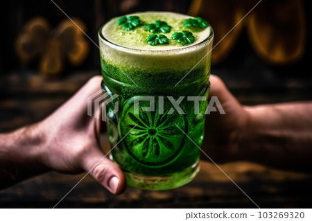 A close-up shot of a hand holding a pint of green beer with a four-leaf clover on the foam, against a rustic wooden background. Generative AI A close-up shot of a hand holding a pint of green beer with a four-leaf clover on the foam, against a rustic wooden background. Generative AI 103269320
