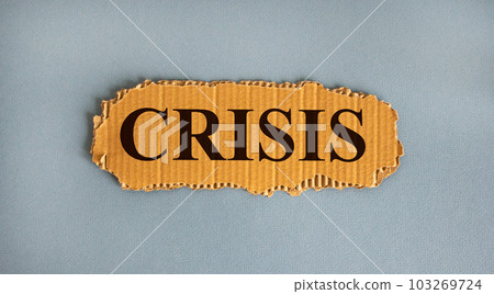 Word 'crisis' on the piece of cardboard on a beautiful white background, copy space. Word 'crisis' on the piece of cardboard on a beautiful white background, copy space. 103269724