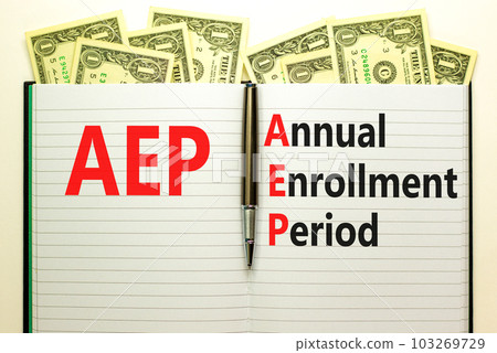 AEP symbol. Concept words AEP Annual enrollment period on beautiful white note. Dollar bills. Beautiful white table white background. Medical and AEP Annual enrollment period concept. Copy space. 103269729