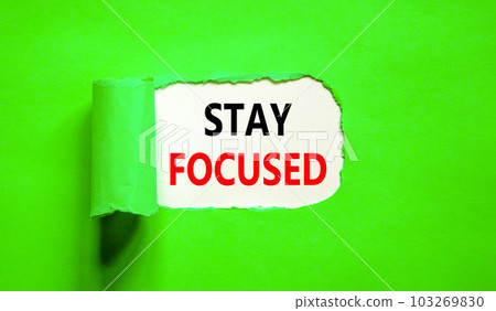 Stay focused symbol. Concept words Stay focused on beautiful white paper on a beautiful green background. Business, support, motivation, psychological and stay focused concept. Copy space. Stay focused symbol. Concept words Stay focused on beautiful white paper on a beautiful green background. Business, support, motivation, psychological and stay focused concept. Copy space. 103269830