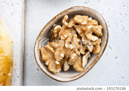 Nuts in bowl, on white stone table background, top view flat lay 103270186