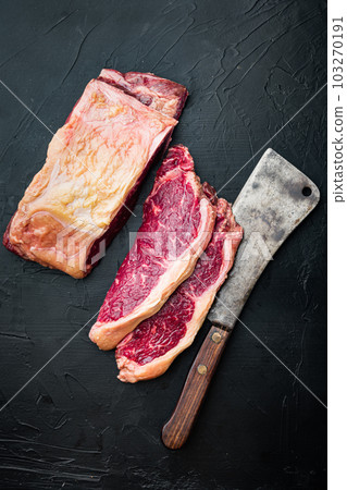 Striploin steak, raw beef butchery cut, on black background, top view 103270191