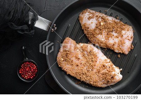 Crispy garlicky chicken raw ingredients, on iron skillet over black background, flat lay Crispy garlicky chicken raw ingredients, on iron skillet over black background, flat lay 103270199
