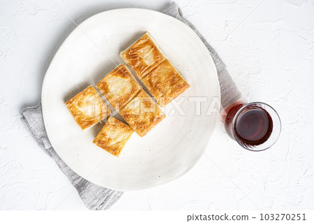 Su Boregi pie, Turkish Tabla borek or burek, on white stone table background, top view flat lay, with copy space for text 103270251