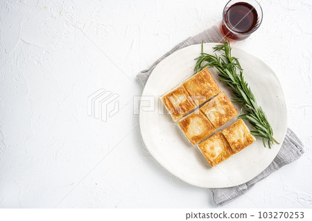 Turkish Pastry for Breakfast Su Boregi, on white stone table background, top view flat lay, with copy space for text 103270253