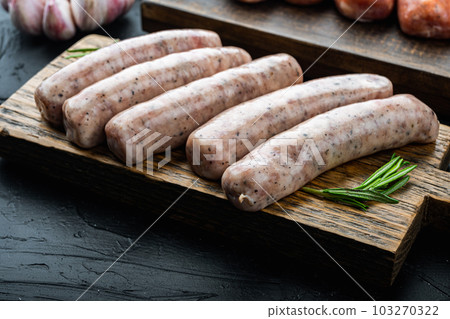 Traditional raw sausages, on black background Traditional raw sausages, on black background 103270322