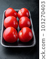Fresh red organic tomatoe, on black background 103270403