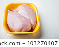 Raw chicken breast fillet in tray, on white background 103270407