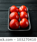 Red tomatoe, on black wooden table 103270410