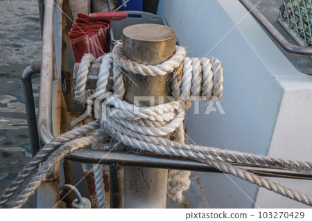 Photograph of white rope wrapped around a steel bollard on King Island Photograph of white rope wrapped around a steel bollard on King Island 103270429