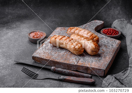 Delicious grilled sausages from chicken or pork meat with salt, spices and herbs Delicious grilled sausages from chicken or pork meat with salt, spices and herbs 103270729