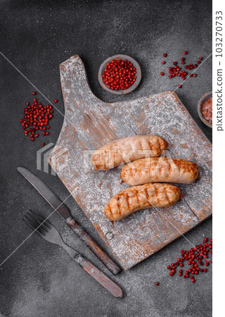 Delicious grilled sausages from chicken or pork meat with salt, spices and herbs 103270733