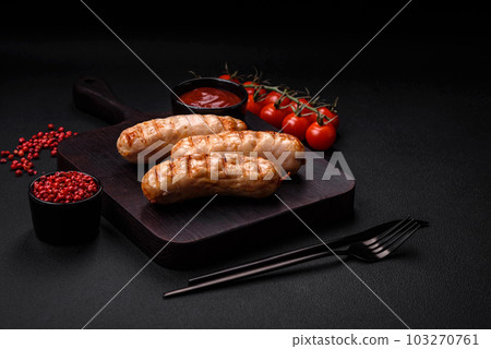 Delicious grilled sausages from chicken or pork meat with salt, spices and herbs 103270761