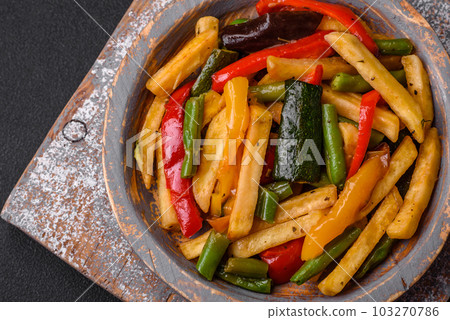 Delicious fried potatoes with bell peppers, asparagus beans, salt and spices Delicious fried potatoes with bell peppers, asparagus beans, salt and spices 103270786