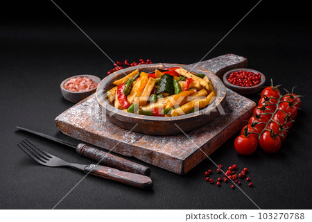 Delicious fried potatoes with bell peppers, asparagus beans, salt and spices Delicious fried potatoes with bell peppers, asparagus beans, salt and spices 103270788