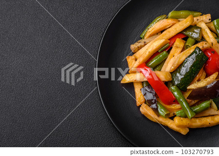 Delicious fried potatoes with bell peppers, asparagus beans, salt and spices Delicious fried potatoes with bell peppers, asparagus beans, salt and spices 103270793