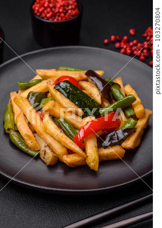 Delicious fried potatoes with bell peppers, asparagus beans, salt and spices 103270804